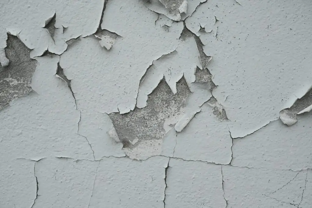 Peeling paint reveals the aged, weathered surface.